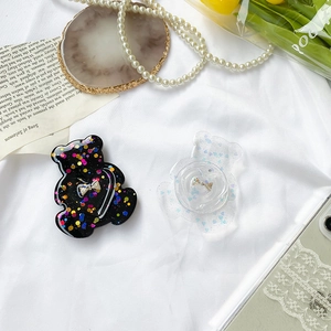 Detail shot of cute bear shaped collapsible phone grips with glitter and bow design