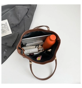Spacious interior of brown tote bag showing organized daily essentials and compartments