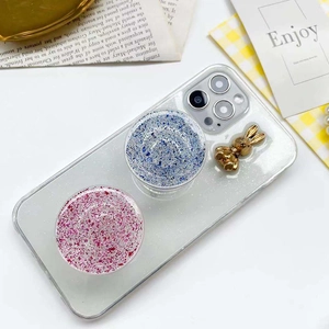 Detail of glitter phone case with gold rabbit charm and dual collapsible sockets