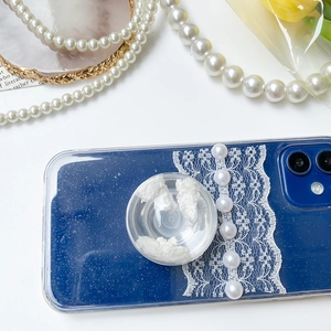 Close-up of blue starry phone case with lace, white pearls and transparent pop-out stand