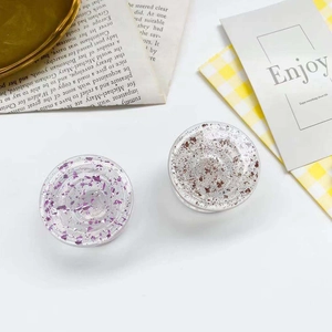 Detail of clear epoxy phone grips featuring shimmering purple and silver foil flakes