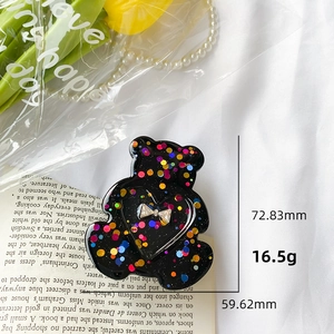 Detailed view of black glitter bear phone grip with silver bow and size measurements