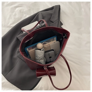Macro view of burgundy leather tote bag interior showing large capacity for tablet and items