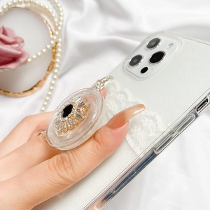 Luxury phone grip featuring a black gemstone and rhinestones on a sparkling lace case