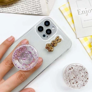 Close-up of a glittering telescopic phone socket with purple sequins and a gold rabbit icon
