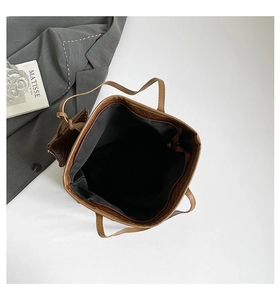 Detailed top view of brown woven tote bag with inner lining, zipper pocket and mini pouch