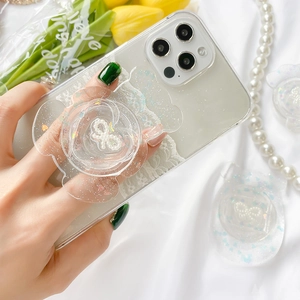 Sparkly glitter flower phone grip with pearl bow on white smartphone, hand-held shot