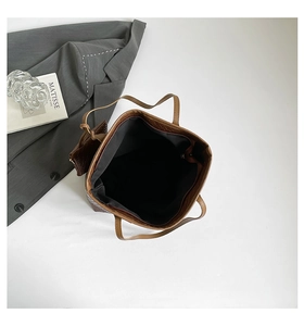 Top view of large dark brown woven leather tote bag with matching interior pouch