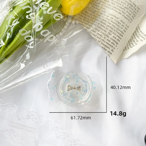 Detail view of a glitter bow candy phone grip with dimensions 61.72mm by 40.12mm