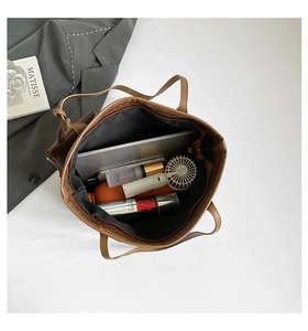 Interior view of large brown woven tote bag showing spacious storage for essentials