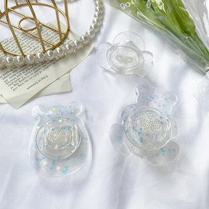Glittery heart and bear phone grip holders with pearls on white silk background