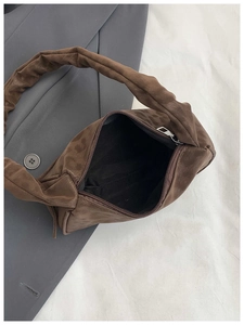 Détail d'un sac à bandoulière léopard avec zip argenté et poignée plissée élégante