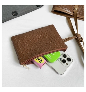 Detailed macro of vintage brown woven leather texture with high-quality gold metal zipper