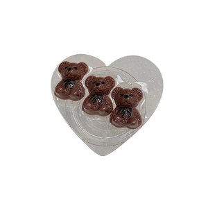 Sparkly heart-shaped hair clip featuring three 3D brown bears with black bowties