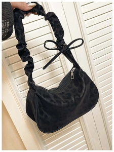 Détail du sac à bandoulière léopard noir avec bandoulière plissée et nœud décoratif élégant