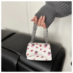 Detail of white mini crossbody bag with colorful lip prints and silver chain strap