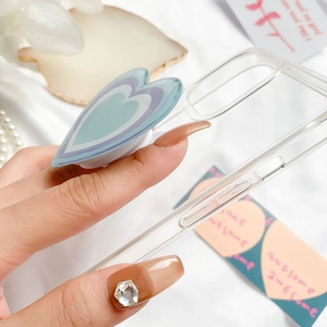 Detail of hand holding phone case with multi-layered blue and purple heart grip