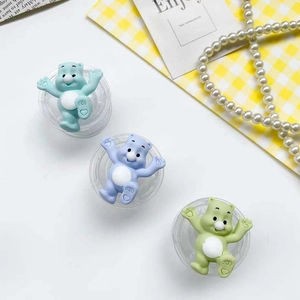 Macro detail of cute colorful cartoon bear phone grip accessories in pastel blue green and purple