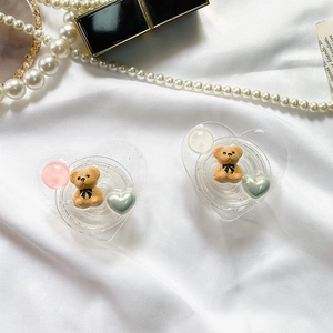 Detail of heart-shaped phone grips with cute brown bear and colorful beads decoration