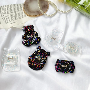Sparkly glitter bowknot phone grip with rhinestone bear and candy shapes on white fabric