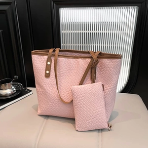 Pink woven tote bag set with brown leather straps and matching small pouch