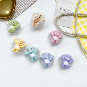 Detailed view of colorful cartoon bear phone grip accessories on transparent bases
