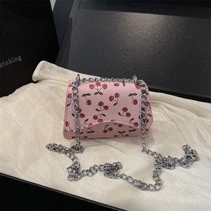 Pink leather crossbody bag with cherry prints and silver chain in a premium gift box