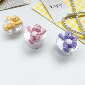 Close-up of cute cartoon bear phone socket stands in yellow, pink and purple colors