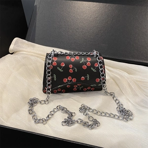 Minimalist black chain bag with cherry print in a luxury gift box packaging
