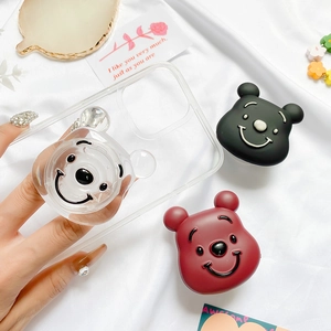 Close-up of cute bear phone socket grip in black, clear and dark red finishes