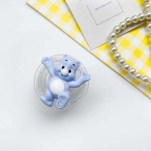 Macro shot of cute light blue bear phone stand with heart details on a bright background