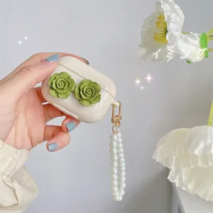 Detail of AirPods Pro case with green 3D camellia flowers and pearl wrist strap