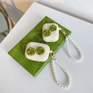 Detail of floral AirPods case with green 3D roses and a white pearl wrist strap
