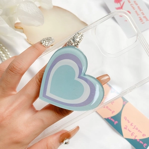 Collapsible heart shaped phone grip with blue and purple drip glue design on a clear case