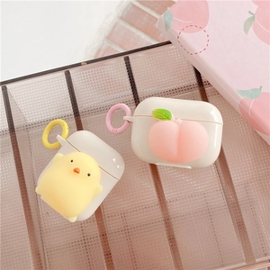 Detail view of cute 3D chick and peach silicone cases for AirPods with metal keyrings