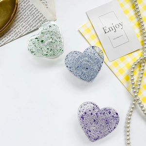 Sparkly glitter heart-shaped phone grip stand in green blue and purple colors