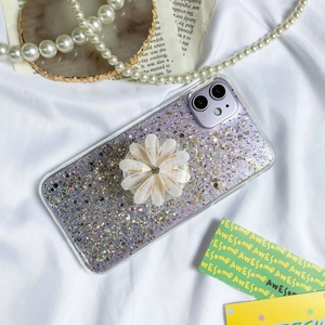 Detailed view of purple glitter iPhone case with 3D white daisy flower pop grip holder
