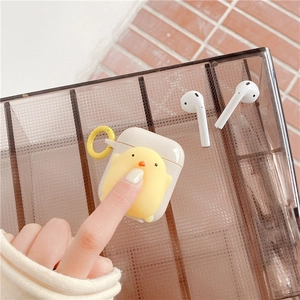 Detail of yellow cartoon chicken AirPods case with squeeze toy and yellow keyring clip