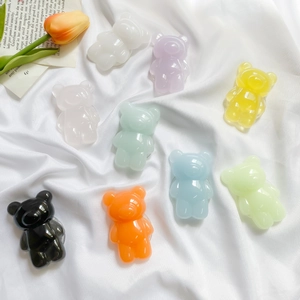 Flat lay of colorful 3D bear phone grips in nine vibrant gummy colors on white fabric