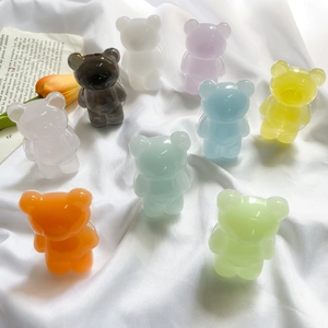 Detailed view of nine colorful 3D resin bear phone grips on a silk fabric background