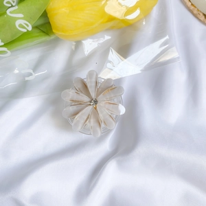 Detail of floral phone socket with pearl texture petals and a sparkling crystal center