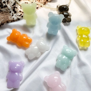 Detail of colorful resin gummy bears on satin background for phone grip accessories