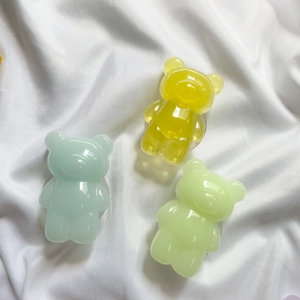 Detail of three colorful 3D resin bear phone sockets in blue, yellow and green colors