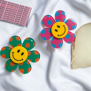 Detailed view of flower-shaped phone grips with colorful polka dots and smiley faces