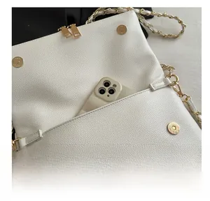 Macro shot of white lychee leather handbag interior pocket with a smartphone for size