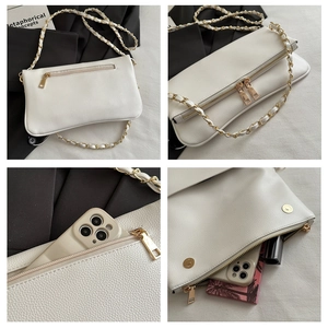 Detail of white lychee leather texture, gold chain strap and interior storage capacity