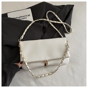 Detail of white lychee pattern leather bag featuring gold woven chain strap and dual zippers