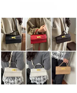 Chic Kelly-style handbag with gold buckle closure and textured leather detail