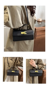 Close-up of black lychee leather crossbody bag with elegant gold metal lock and handle