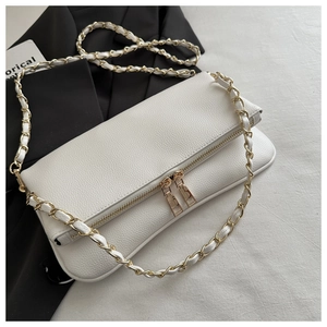 Detailed close-up of white lychee texture leather handbag with dual gold zippers and chain